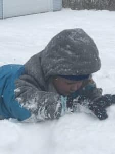 Child playing in the snow.